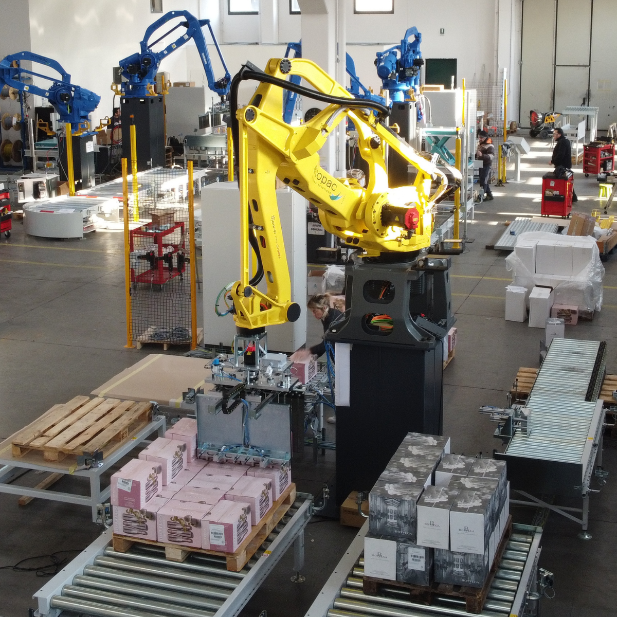 sistema automatico di pallettizzazione in cui un robot antropomorfo preleva da un nastro trasportatore delle scatole per posizionarli su un pallet